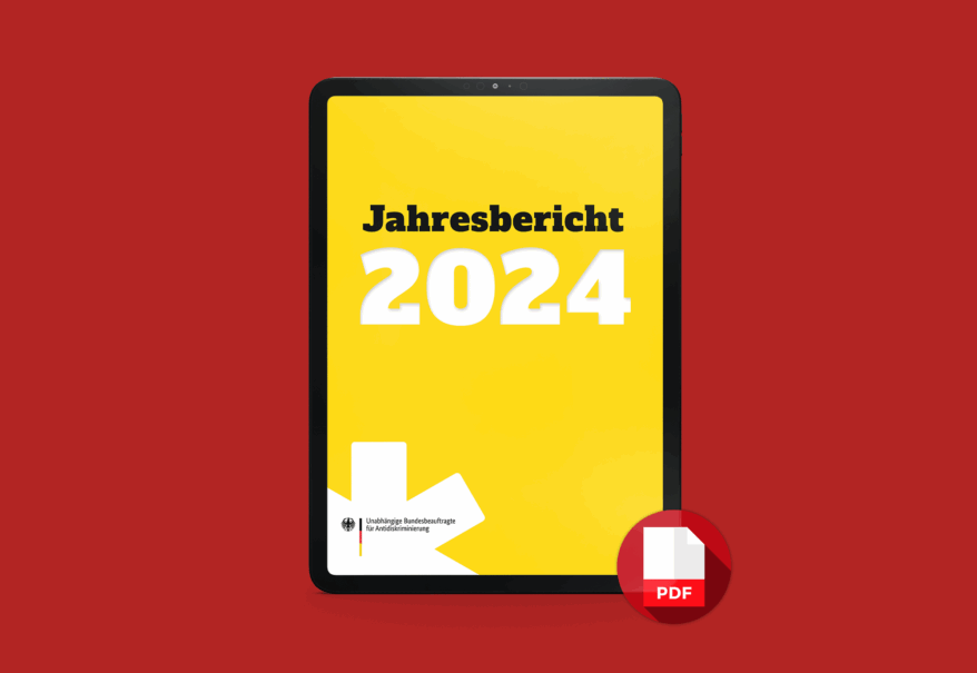 Ein Tablet zeigt das gelbe Titelblatt des Jahresberichts 2024 der Antidiskriminierungsstelle des Bundes